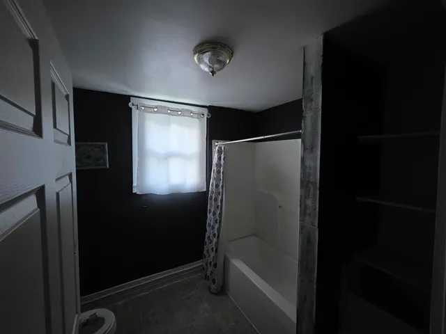 a bathroom with a glass shower door