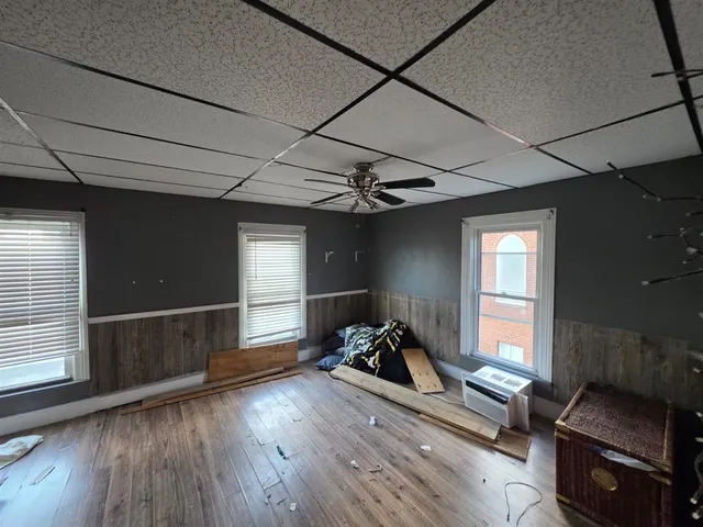 a view of a workspace with furniture and windows