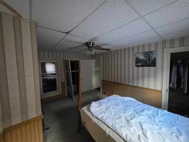 a bedroom with a bed and a walk in closet