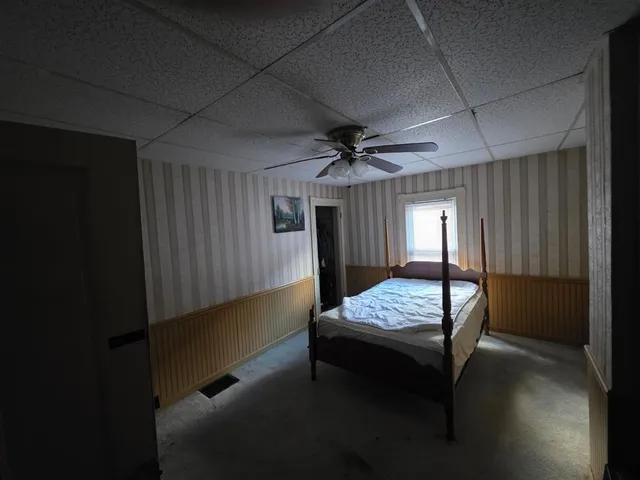 a bedroom with furniture and window