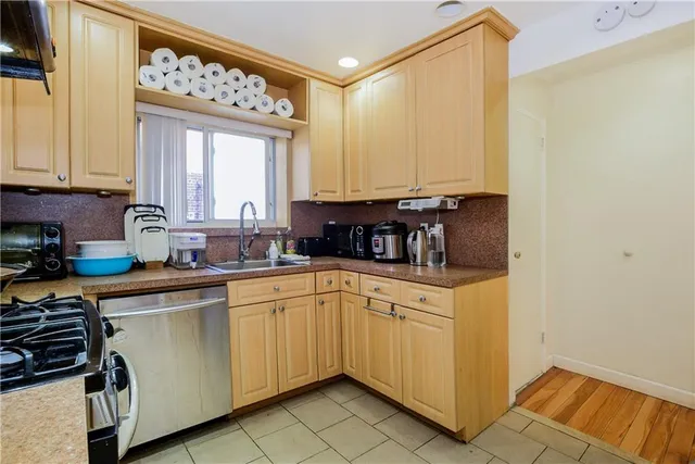 a kitchen with a sink cabinets and window
