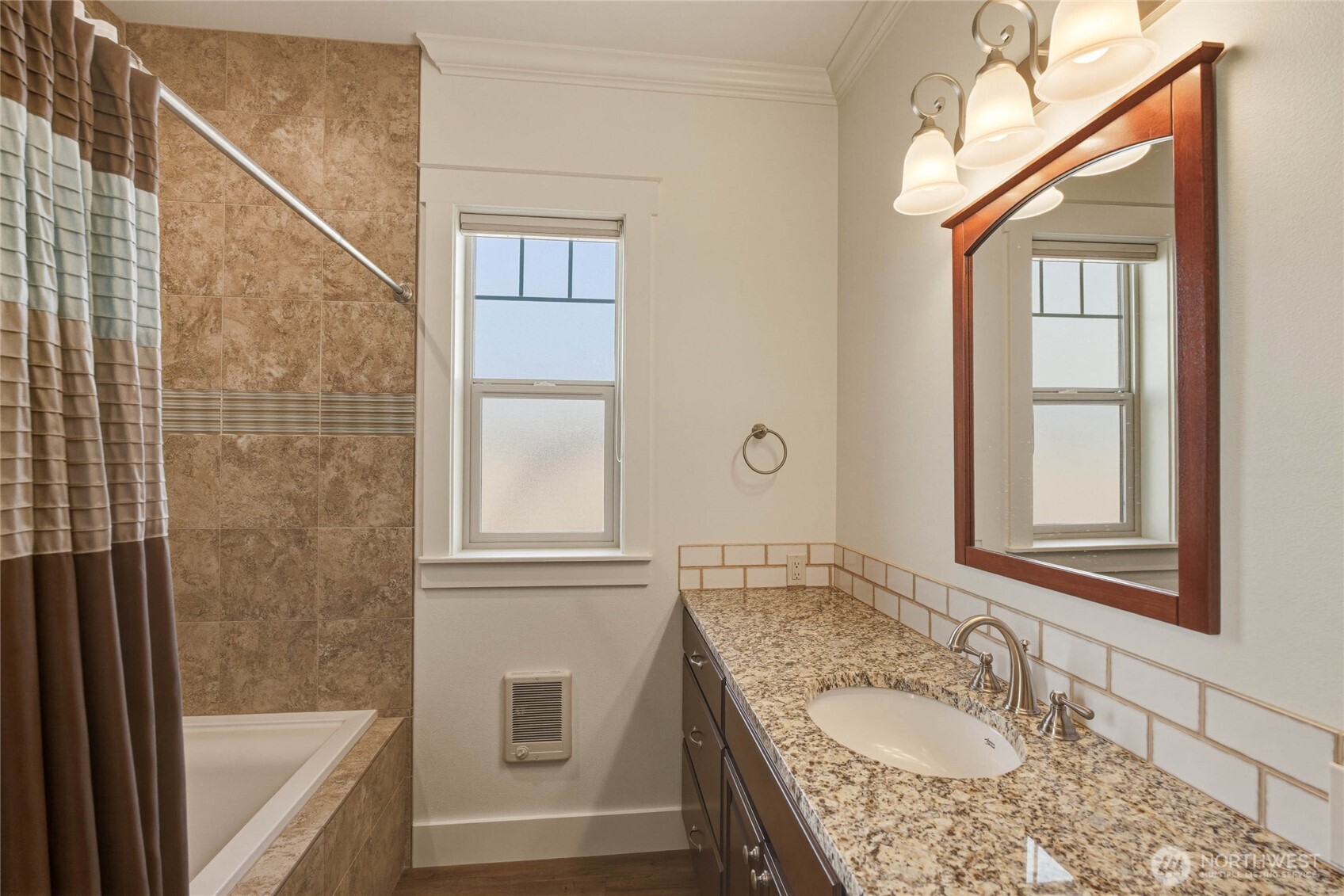 726 L Street Southwest Quincy, WA 98848 - Photo 32 of 40 a bathroom with a granite countertop bathtub a sink and a window