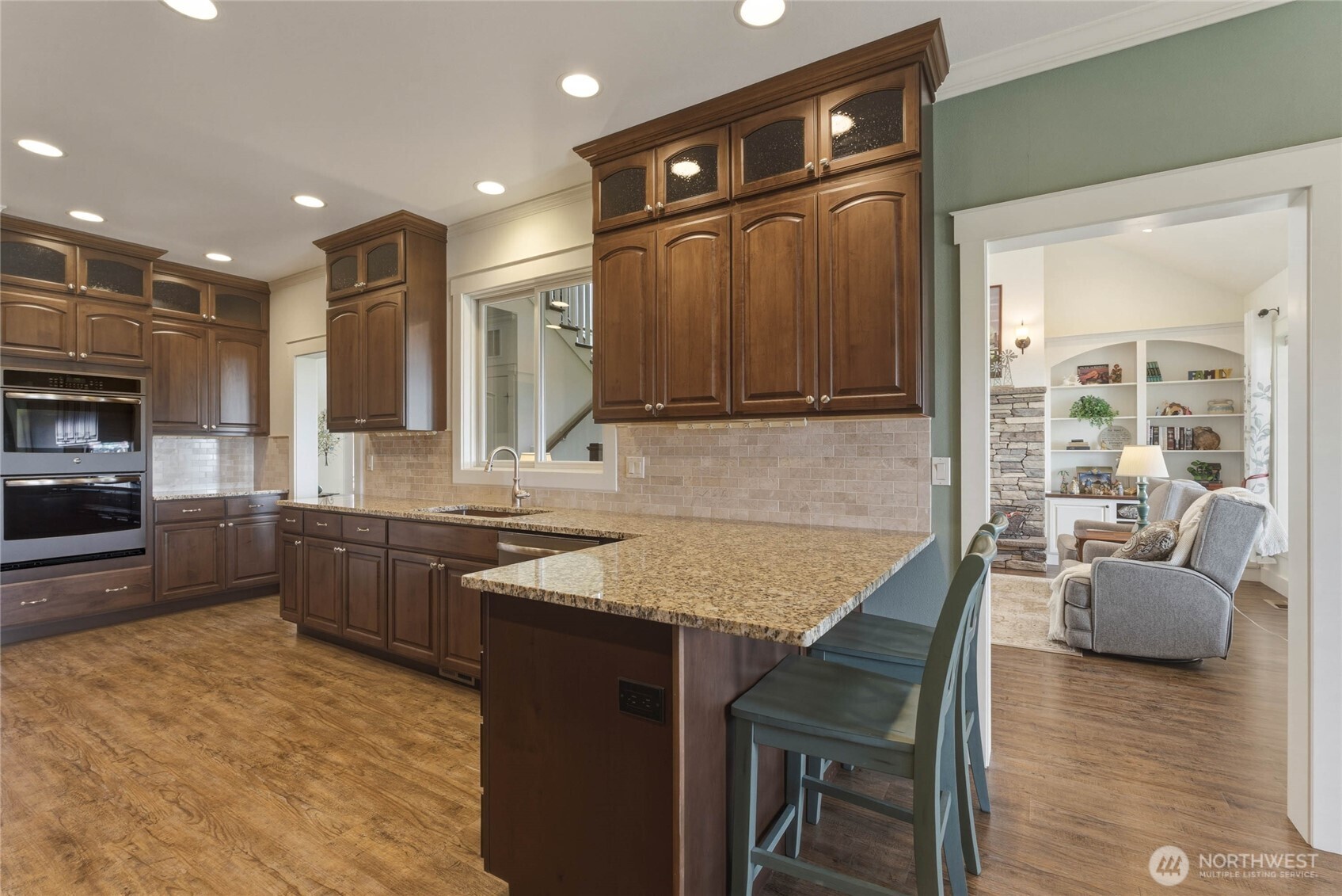 726 L Street Southwest Quincy, WA 98848 - Photo 10 of 40 a kitchen with kitchen island granite countertop wooden cabinets and a refrigerator