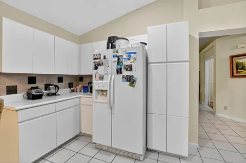 a bedroom with a bed and a flat tv screen on wall