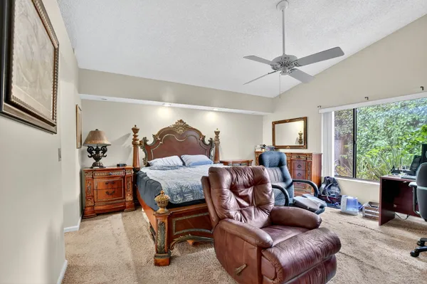 a living room with furniture and floor to ceiling windows