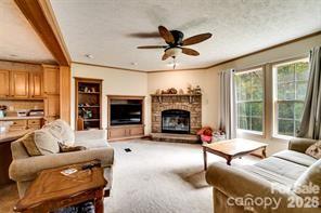 179 Fresh Water Rdg Road Whittier, NC 28789 - Photo 13 of 48 a living room with furniture a flat screen tv and a fireplace