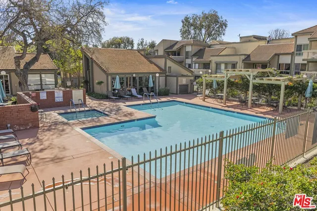 a view of a pathway with a wrought fence