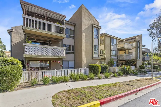 a view of a street with a building in the background