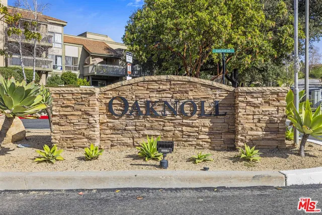 a view of a street with potted plants