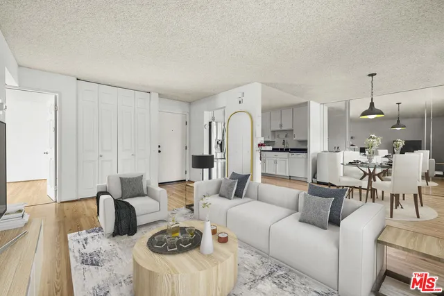 a living room with furniture a fireplace and kitchen view