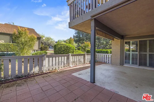 a view of a room with wooden floor and fence