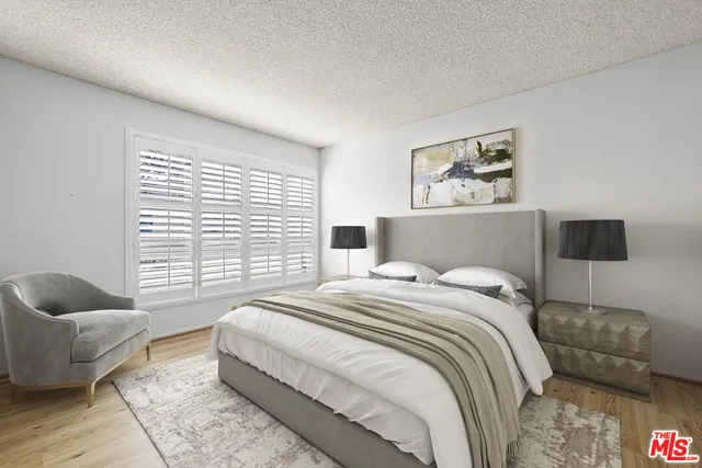 a bedroom with a bed and couch