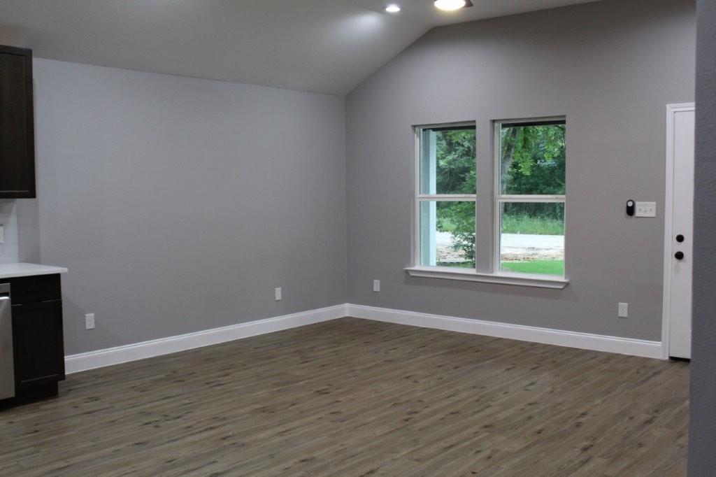 125 Chapperall Drive Mabank, TX 75156 - Photo 6 of 11 a view of an empty room with wooden floor and a window