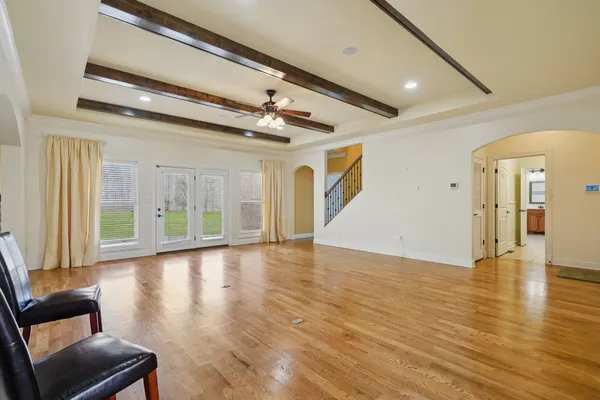 a view of empty room with wooden floor and fireplace