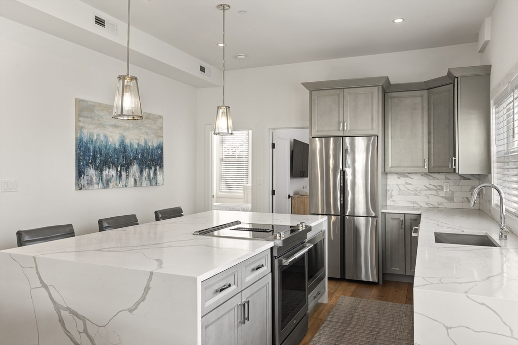 157 Princeton Street, Unit 2 Boston, MA 02128 - Photo 11 of 22 a kitchen with stainless steel appliances a sink stove and refrigerator
