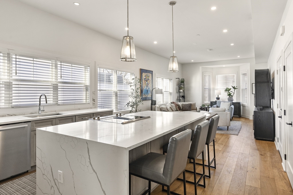 157 Princeton Street, Unit 2 Boston, MA 02128 - Photo 13 of 22 a kitchen with stainless steel appliances granite countertop a stove a sink a oven a dining table and chairs