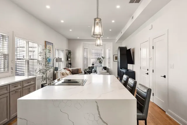 a large kitchen with sink a counter top space stainless steel appliances and a large window