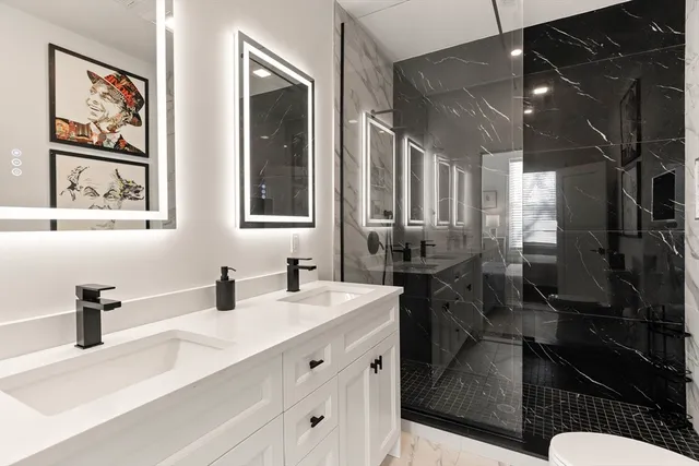 a bathroom with double vanity and a two mirror