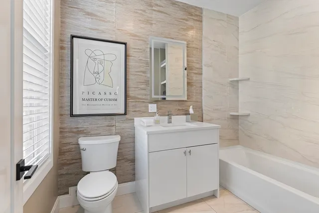 a bathroom with a toilet sink and a bathtub