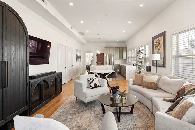 a living room with furniture fireplace and a window