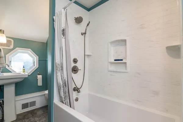a bathroom with a bathtub and a shower