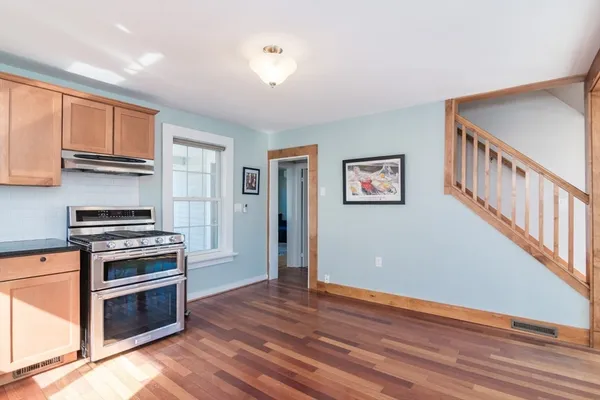 a kitchen with granite countertop a stove and a refrigerator