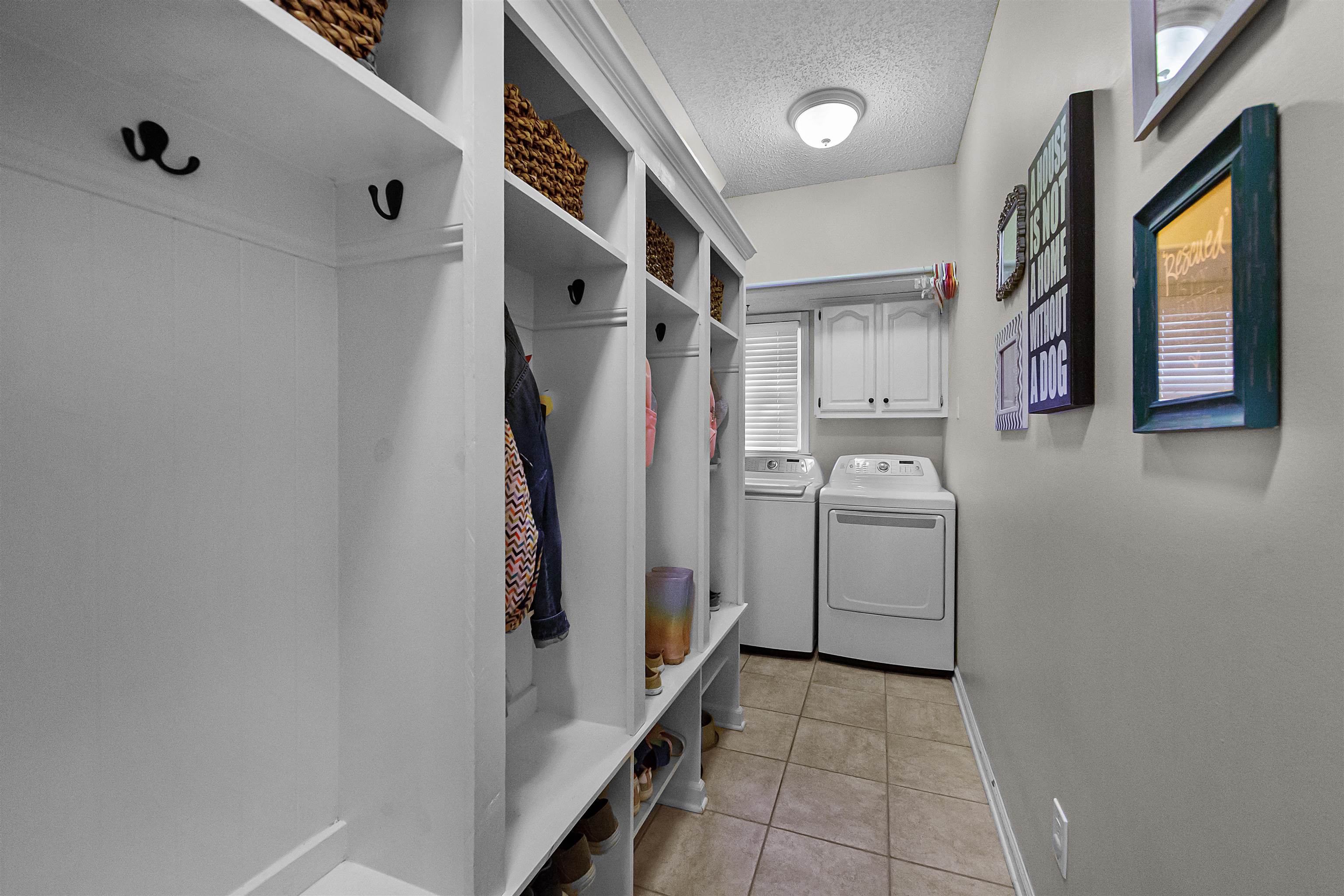 1213 Heather Ridge Cove Collierville, TN 38017 - Photo 12 of 25 a utility room with cabinets washer and dryer