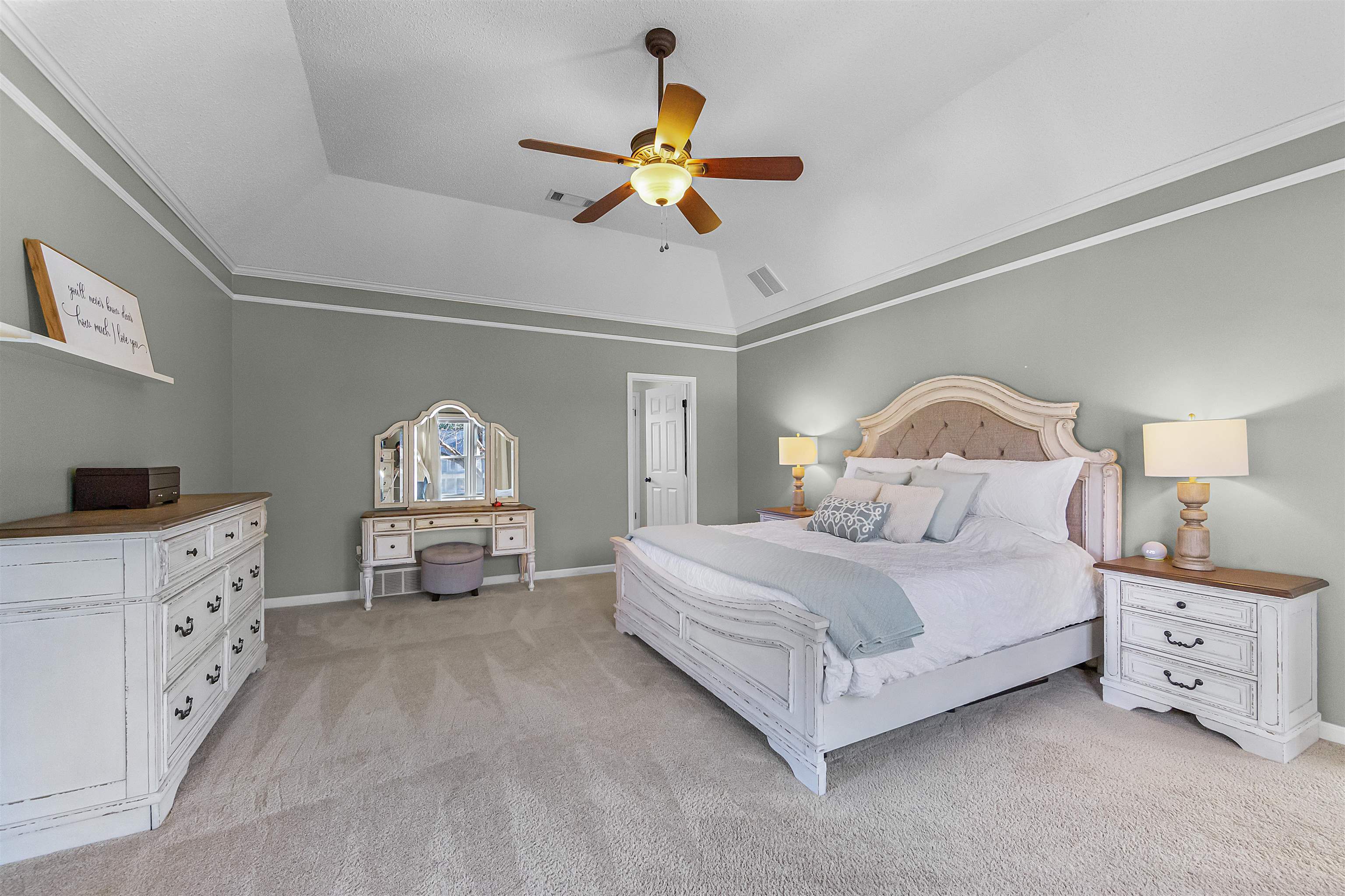 1213 Heather Ridge Cove Collierville, TN 38017 - Photo 13 of 25 a bedroom with a bed and a chandelier