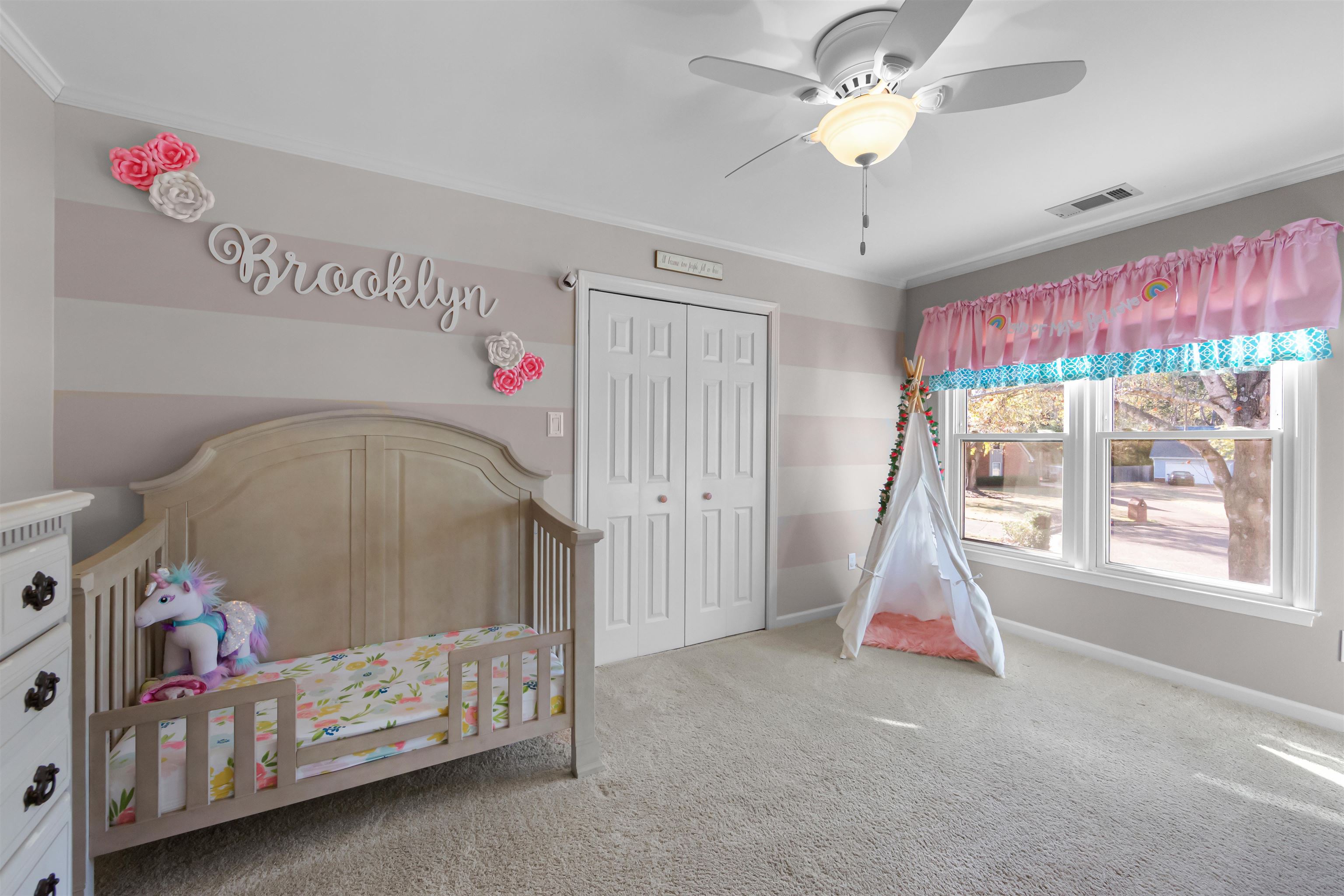 1213 Heather Ridge Cove Collierville, TN 38017 - Photo 18 of 25 a bedroom with a bed and a chandelier