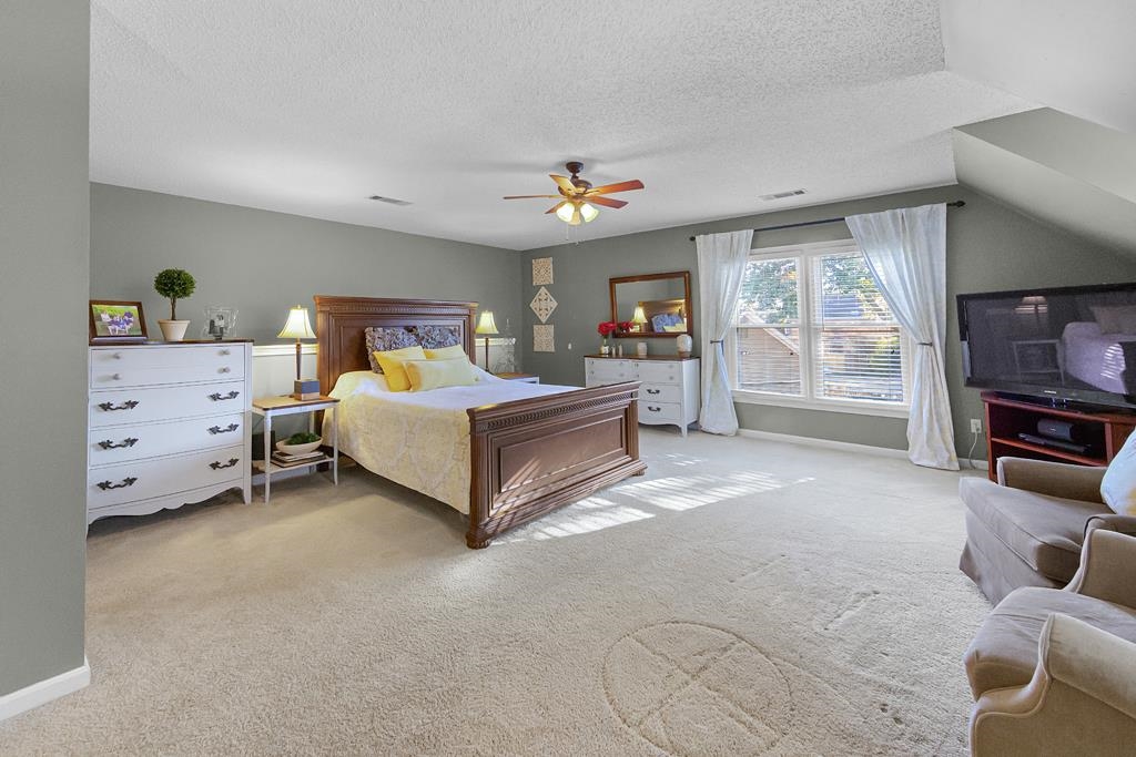 1213 Heather Ridge Cove Collierville, TN 38017 - Photo 20 of 25 a bedroom with a bed and dresser