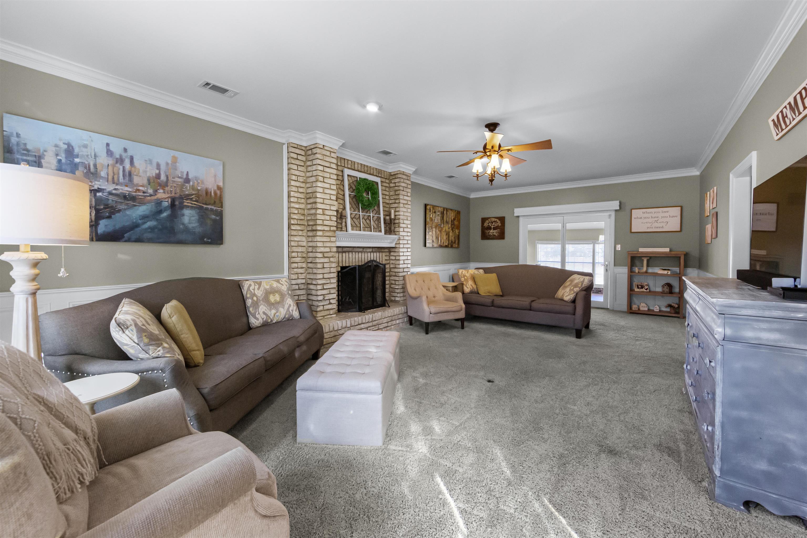 1213 Heather Ridge Cove Collierville, TN 38017 - Photo 4 of 25 a living room with furniture a fireplace and a flat screen tv