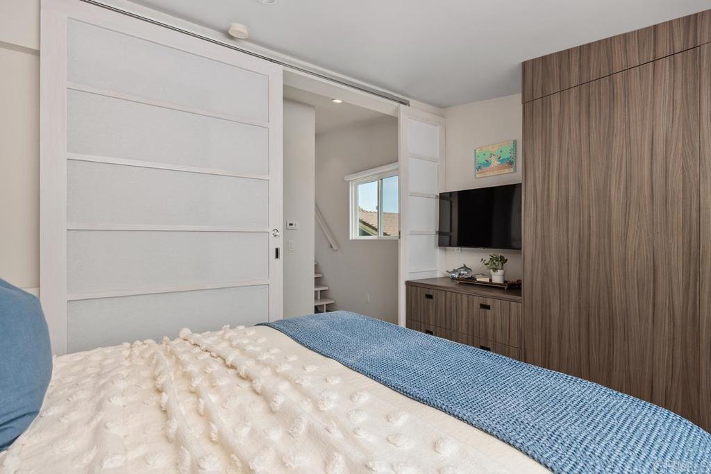 1856 Parliament Road Encinitas, CA 92024 - Photo 28 of 42 a bedroom with a bed and a flat screen tv