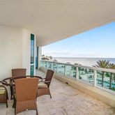 a view of a chairs and table in the balcony