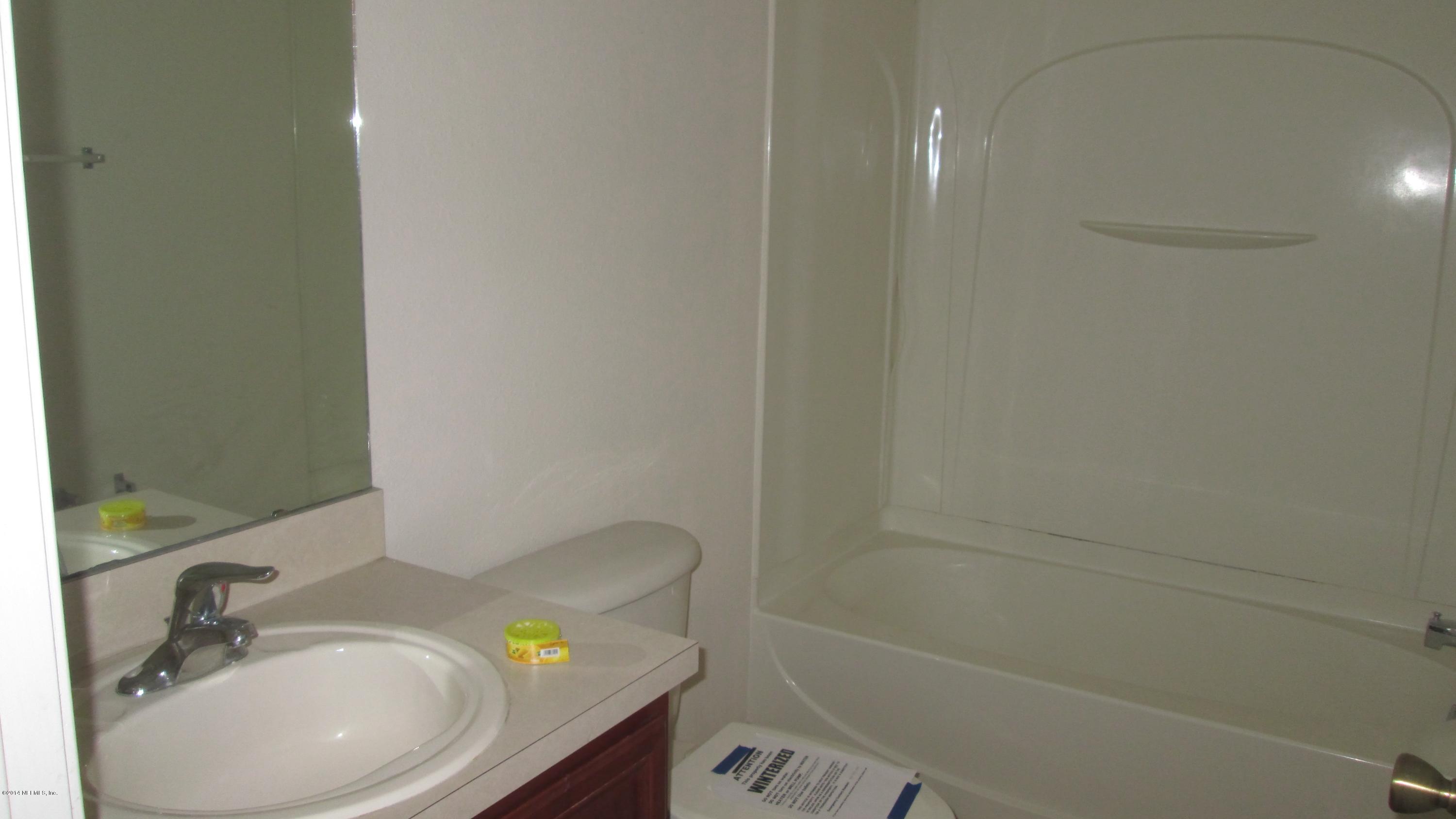 7201 Rampart Ridge Circle West Jacksonville, FL 32244 - Photo 13 of 14 a bathroom with a sink and a mirror