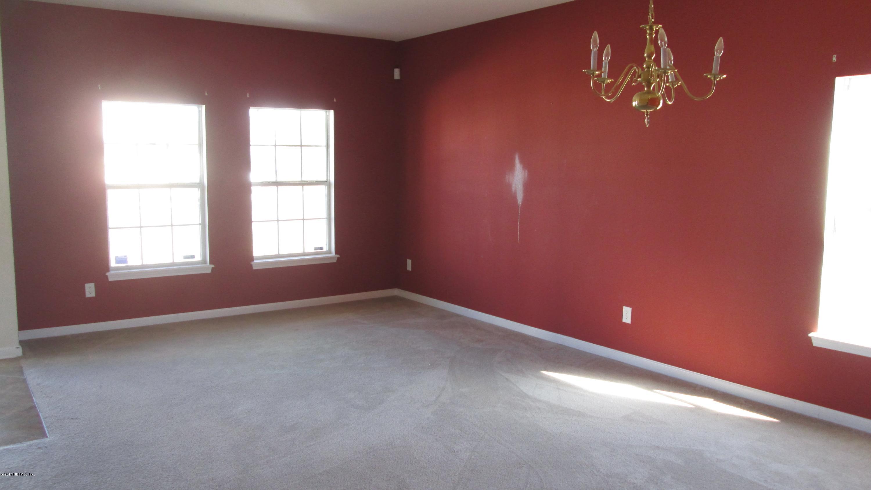 7201 Rampart Ridge Circle West Jacksonville, FL 32244 - Photo 2 of 14 an empty room with windows and chandelier fan