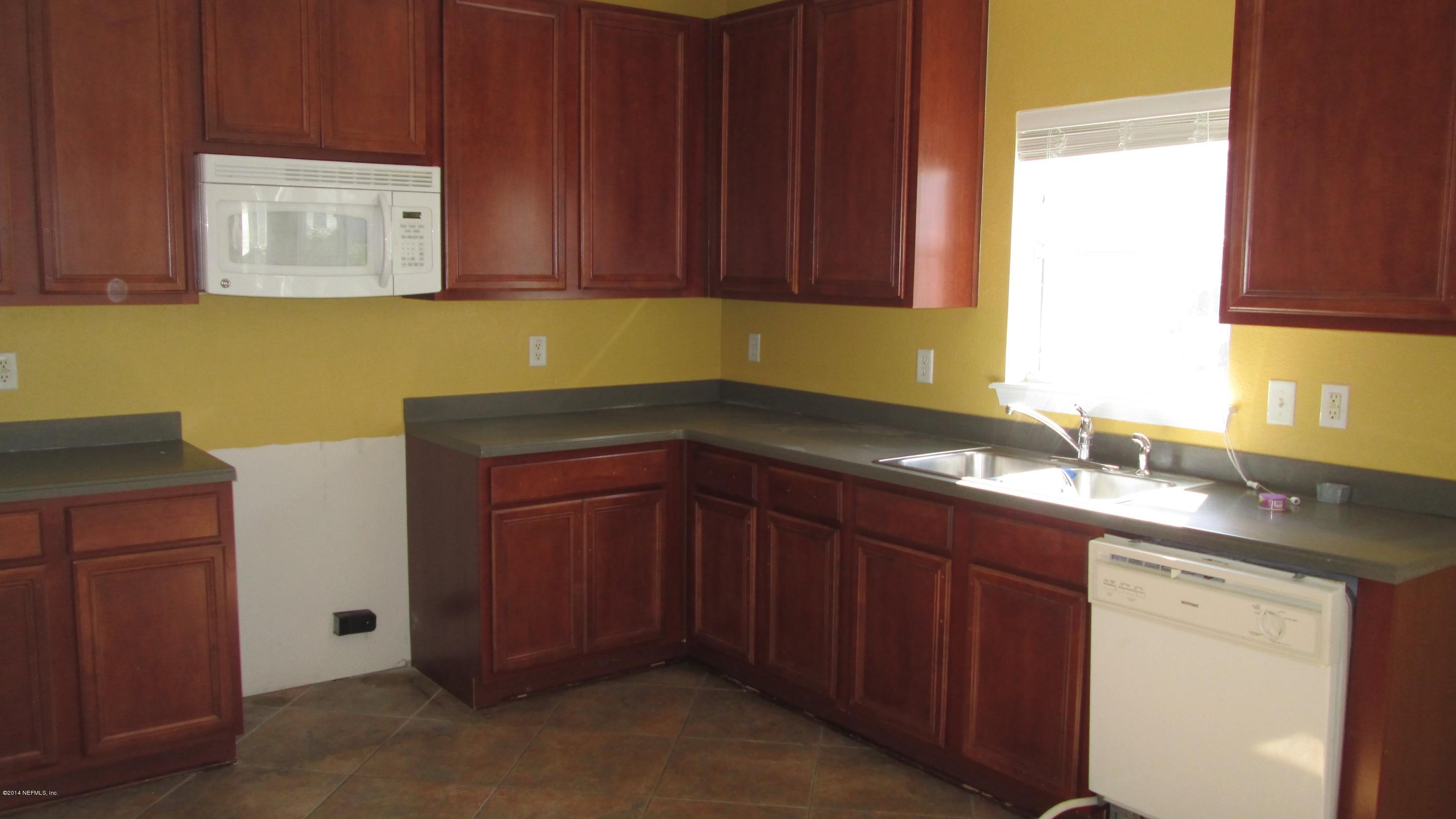 7201 Rampart Ridge Circle West Jacksonville, FL 32244 - Photo 3 of 14 a kitchen with a sink and cabinets