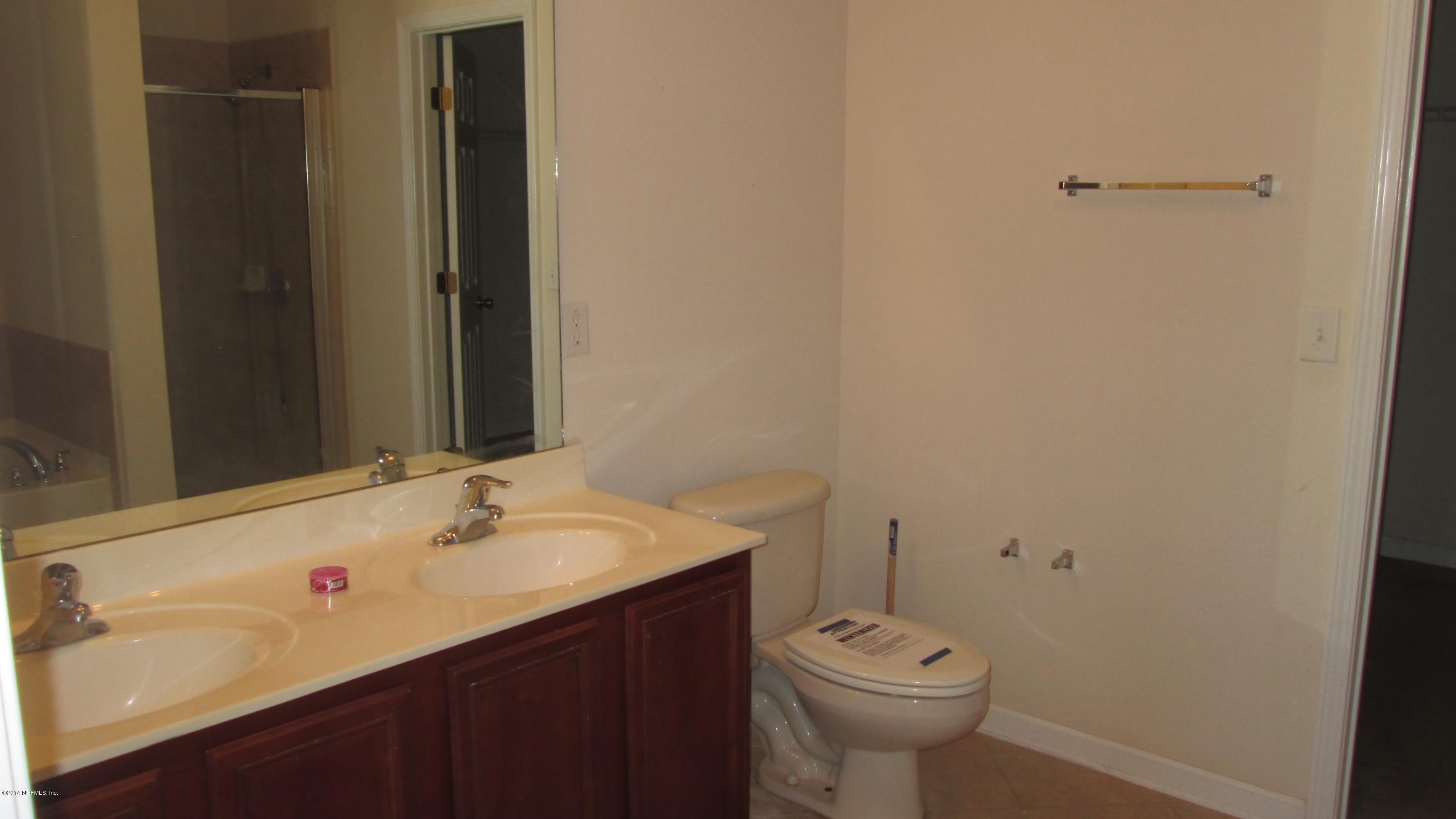 7201 Rampart Ridge Circle West Jacksonville, FL 32244 - Photo 8 of 14 a bathroom with a sink a toilet and a mirror