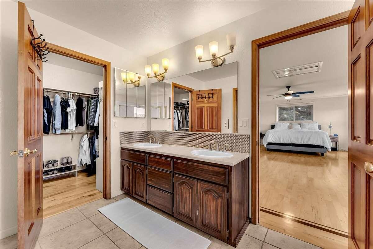 416 Arbor Place Redding, CA 96001 - Photo 11 of 31 a bathroom with a granite countertop sink and a mirror