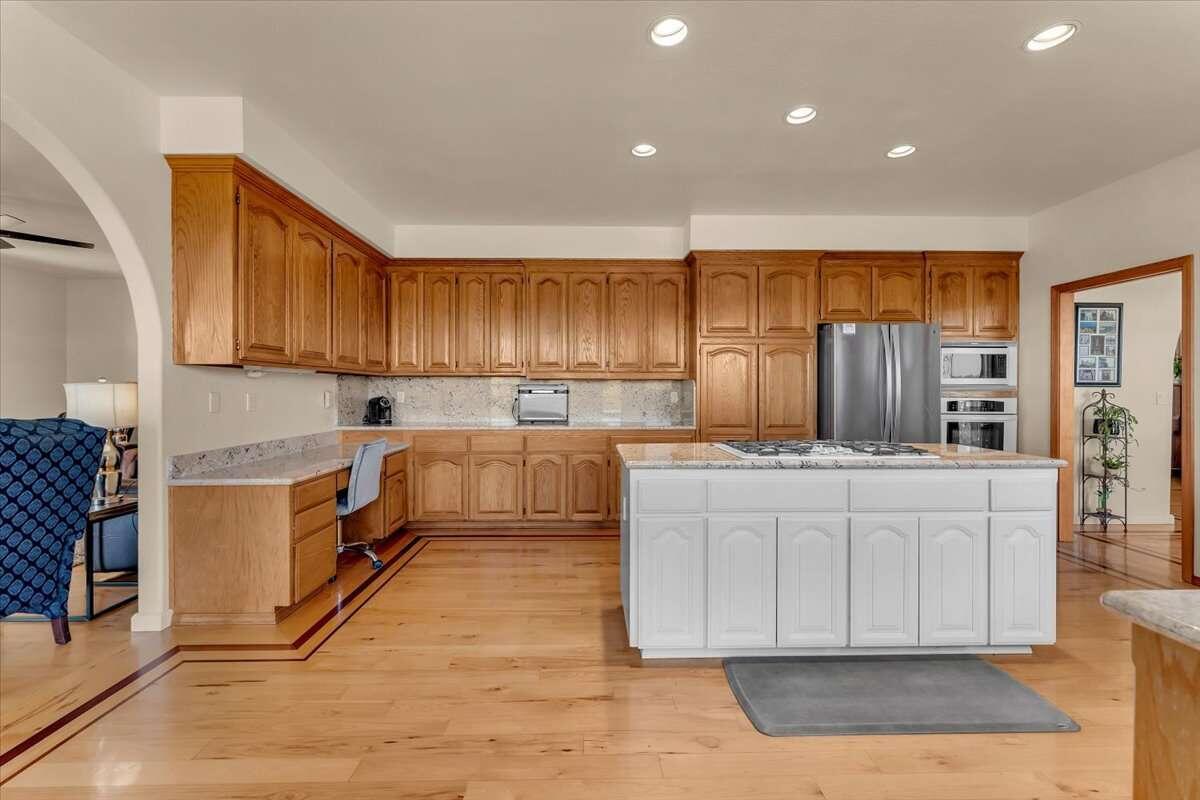 416 Arbor Place Redding, CA 96001 - Photo 16 of 31 a kitchen with stainless steel appliances granite countertop a stove a sink and a refrigerator