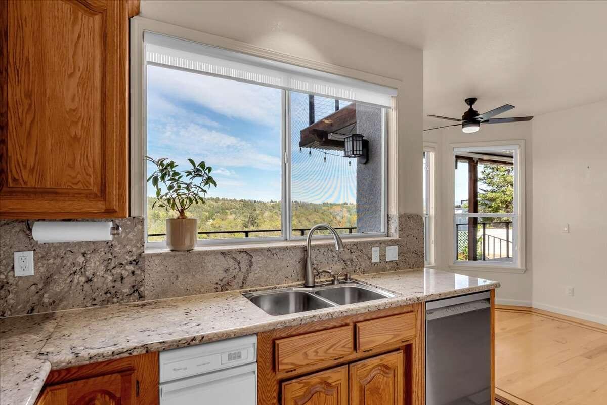 416 Arbor Place Redding, CA 96001 - Photo 17 of 31 a kitchen with a sink and a refrigerator