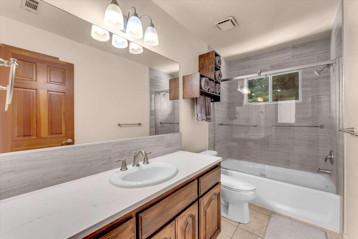 416 Arbor Place Redding, CA 96001 - Photo 27 of 31 a bathroom with a sink a toilet a mirror and shower