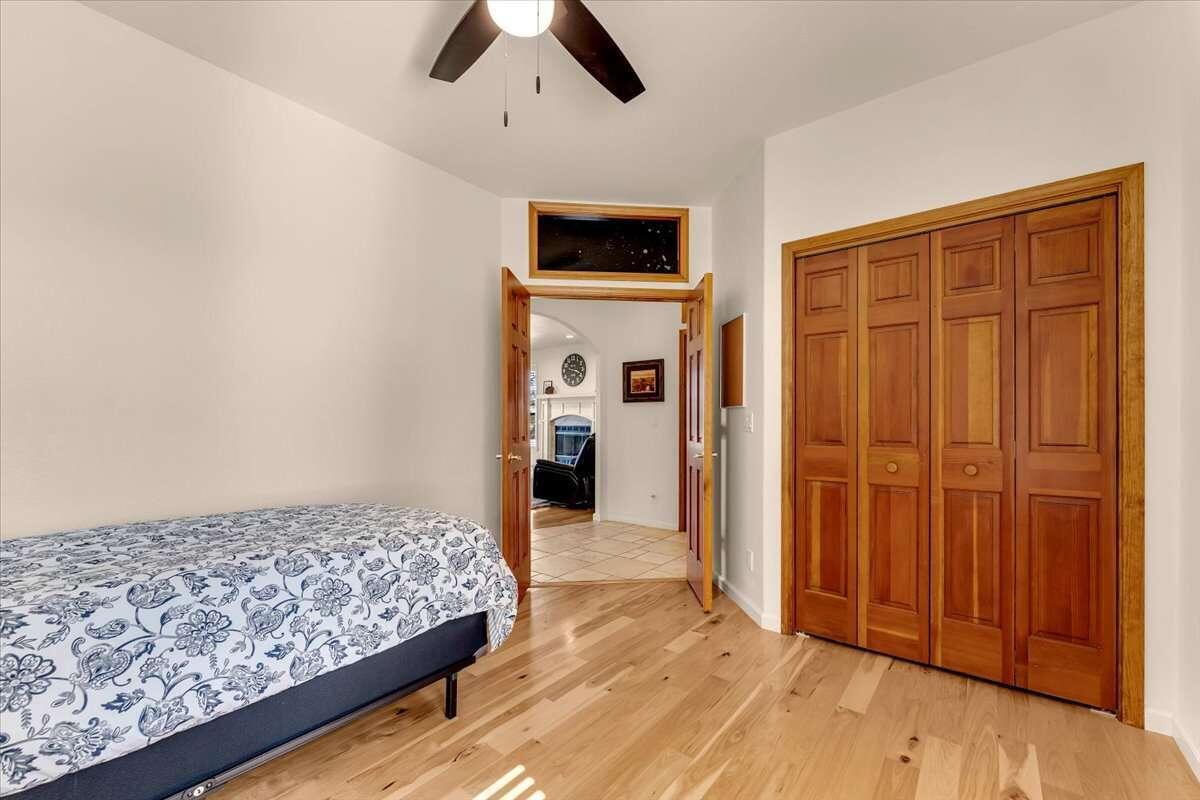 416 Arbor Place Redding, CA 96001 - Photo 8 of 31 a bedroom with a bed and a flat tv screen