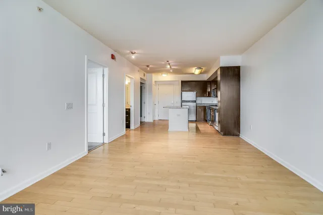 a view of kitchen with refrigerator and window
