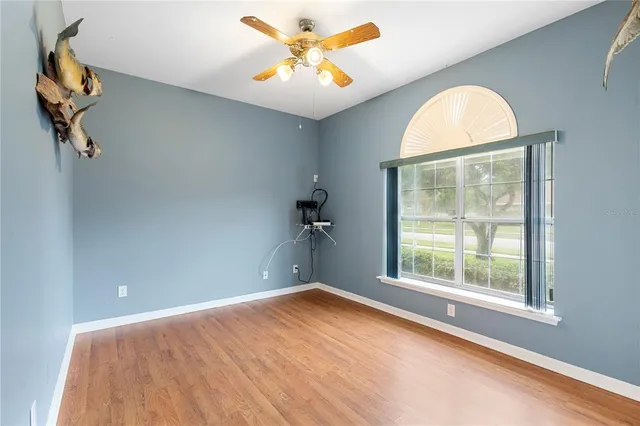 a bedroom with a bed and a ceiling fan