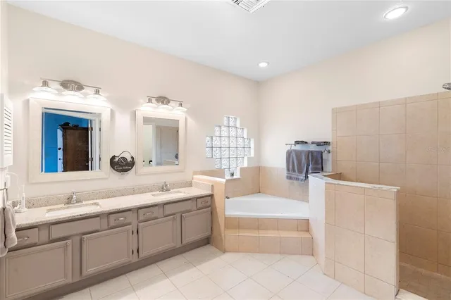 a bathroom with a sink a toilet and a large mirror