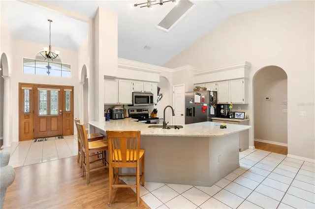 a view of kitchen and dining room with furniture large window and wooden floor