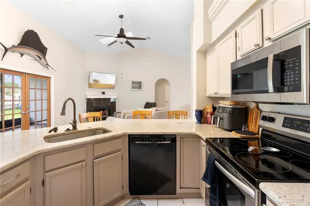 a kitchen with a sink appliances and cabinets