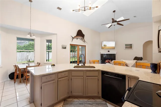 a kitchen that has a sink a stove and a table in it