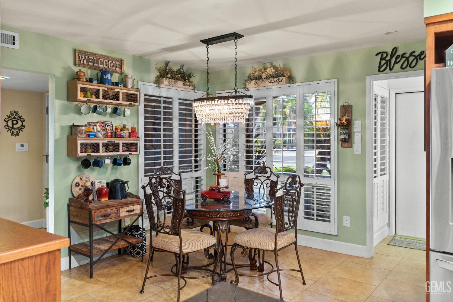 Undisclosed Address Bakersfield, CA 93309 - Photo 11 of 27 a view of a dining room with furniture and a book shelf