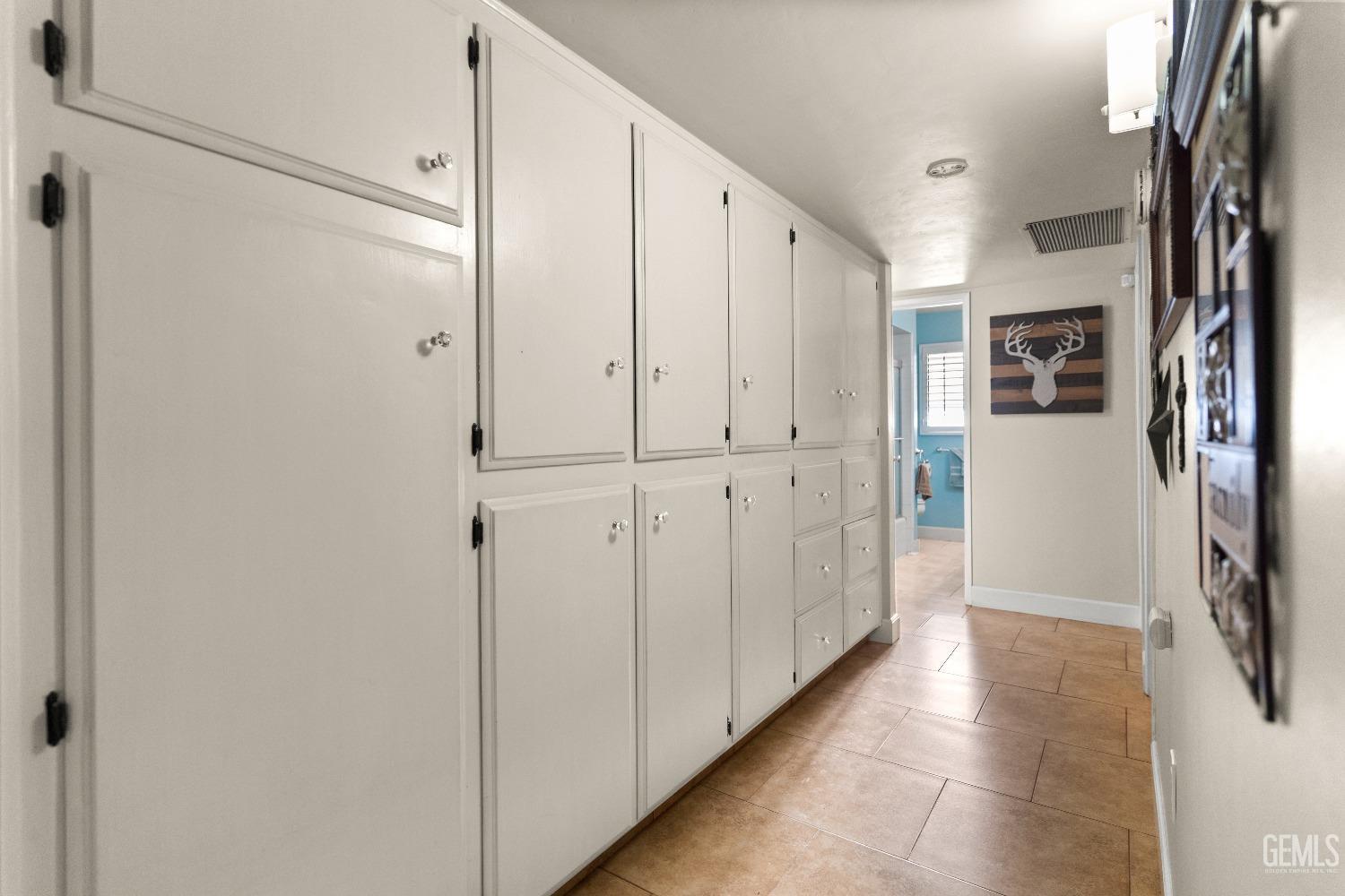 Undisclosed Address Bakersfield, CA 93309 - Photo 13 of 27 a view of a hallway with a refrigerator